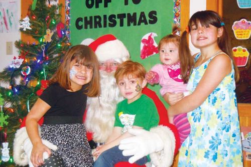L-r siblings Madison, Logan, Danielle and Alesha with Santa at the NFCS Christmas Open House at the Child care Centre in Sharbot Lake